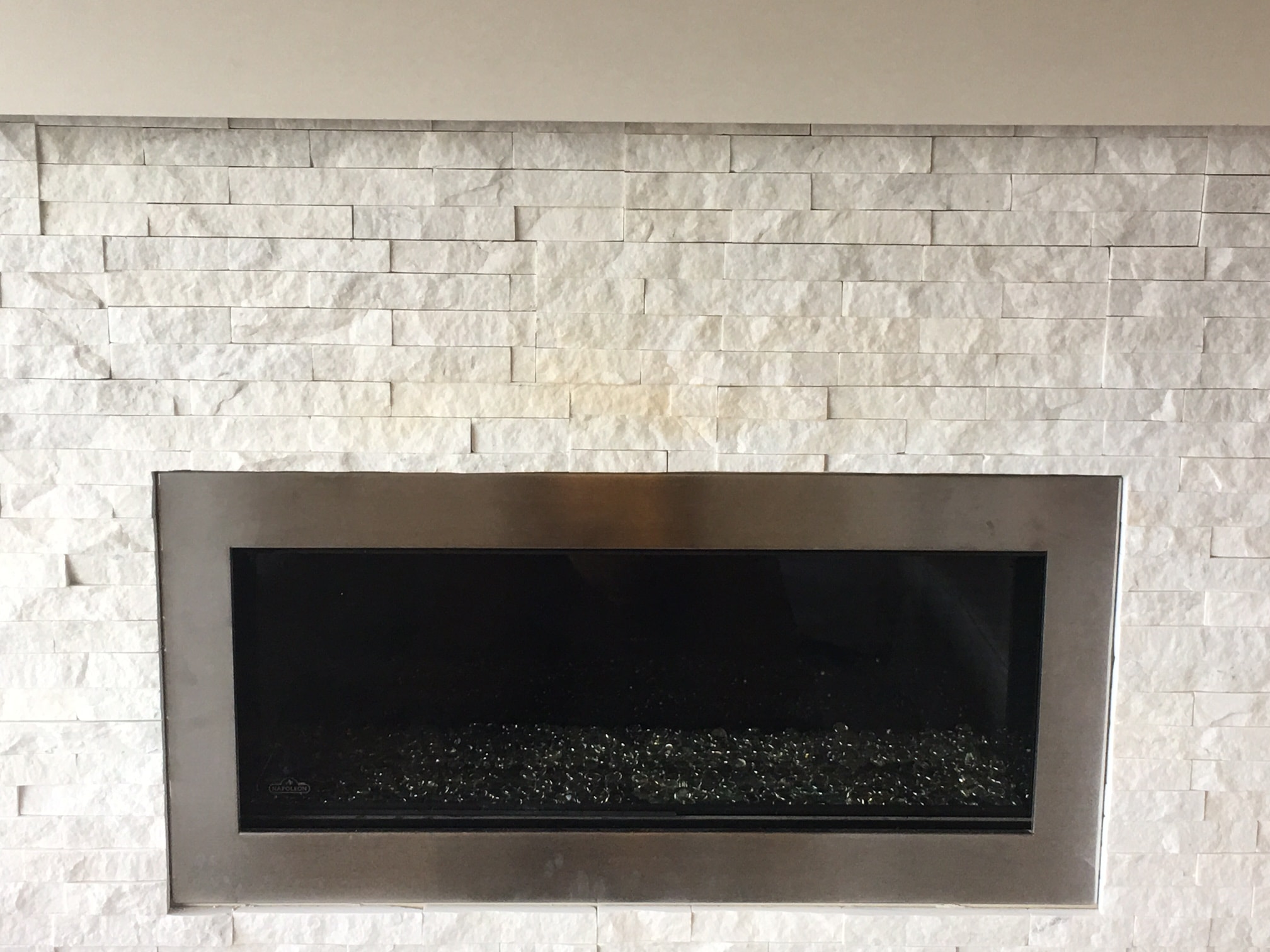 Gas exhaust discoloring stacked stone on a fireplace